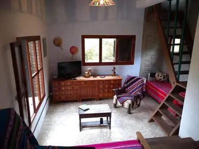 a living room with a couch and a tv at Casa Monte in Villa Icho Cruz