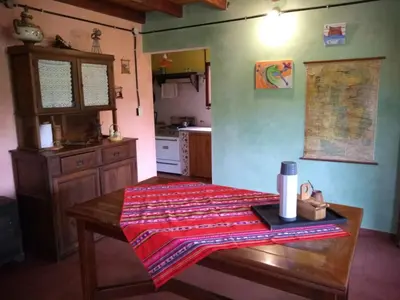 a kitchen with a table with a blanket on it at Casa Monte in Villa Icho Cruz