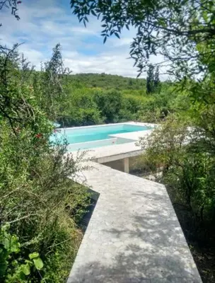 a swimming pool in the middle of a forest at Casa Monte in Villa Icho Cruz