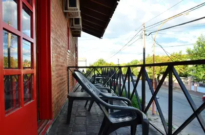 a row of benches sitting on a balcony at Posada Alpenrose Neu in Villa Carlos Paz