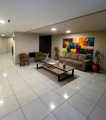 a living room with a couch and a table at Miralejos 7 Turquesa in Villa Carlos Paz