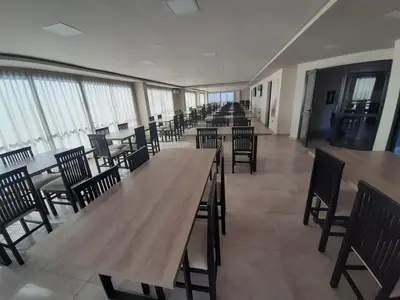 a row of tables and chairs in a room with windows at Miralejos 7 Turquesa in Villa Carlos Paz
