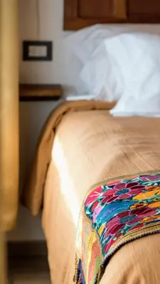 a close up of a bed in a bedroom at Tantasiña Cabañas Suites de Montaña in San Javier