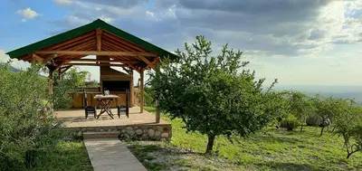 a gazebo with a table on a hill at Tantasiña Cabañas Suites de Montaña in San Javier