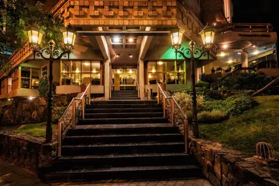 a set of stairs leading to a building at night at Hotel de la Cañada in Cordoba