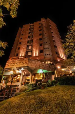 a tall building with lights on it at night at Hotel de la Cañada in Cordoba