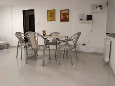 a dining room with a table and four chairs at Departamento Alberdi in Cordoba