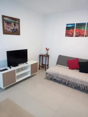 a living room with a couch and a flat screen tv at Departamento Alberdi in Cordoba