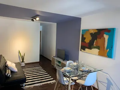 a living room with a glass table and a couch at Torre Magna II, Nueva Cordoba in Cordoba