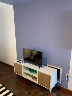 a flat screen tv sitting on top of a cabinet at Torre Magna II, Nueva Cordoba in Cordoba