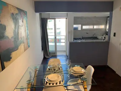 a dining room with a glass table and chairs at Torre Magna II, Nueva Cordoba in Cordoba