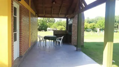 a patio with a table and chairs on it at Luz Alba Cabañas in Mina Clavero