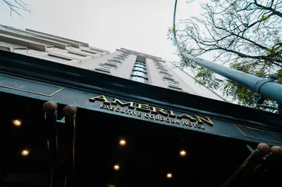 a tall building with a sign on the side of a restaurant at Amérian Executive Córdoba in Cordoba