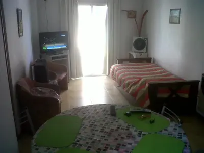 a room with a bed and a table and a television at VICTORIA PARK in Villa Carlos Paz
