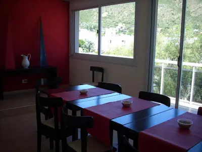 two tables and chairs in a room with windows at VICTORIA PARK in Villa Carlos Paz