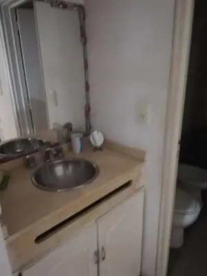 a bathroom with a sink and a toilet at VICTORIA PARK in Villa Carlos Paz