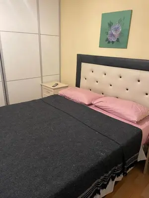 a bedroom with a large bed with a black blanket at VICTORIA PARK in Villa Carlos Paz