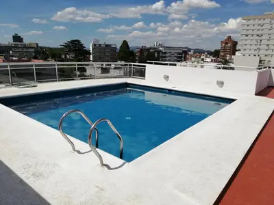 a swimming pool on the roof of a building at VICTORIA PARK in Villa Carlos Paz