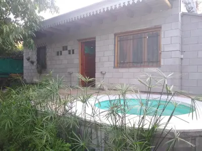 a house with a swimming pool in front of it at Dpto La Bicicleta solar in Villa Independencia