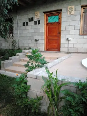 a front door of a house with a red door at Dpto La Bicicleta solar in Villa Independencia