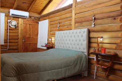 a bedroom with a bed in a wooden room at Amaneceres de San Isidro in José de la Quintana
