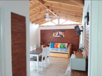 a living room with a couch and a table at Cabañas Matices del Lago in Villa Ciudad Parque