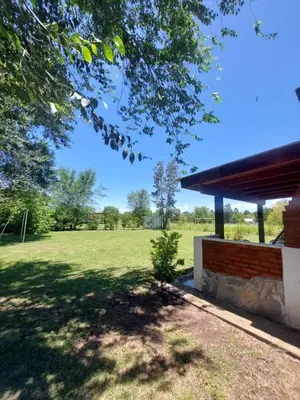 a park with a building and a grass field at Cabañas Matices del Lago in Villa Ciudad Parque