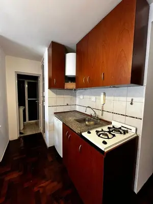 a kitchen with a sink and a stove top oven at Punto Quiros - Monoambiente centrico, a la vuelta del Patio Olmos in Cordoba