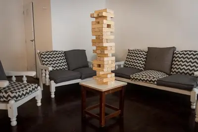 a living room with two couches and a tower of logs at Hotel 376 in Villa Carlos Paz