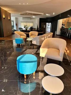 a lobby with couches and chairs and a table at Hotel 376 in Villa Carlos Paz