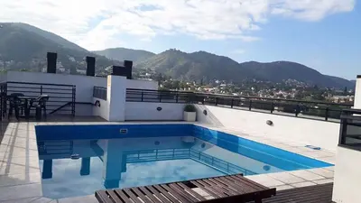 a swimming pool on the roof of a building at Departamento centrico carlos paz in Villa Carlos Paz