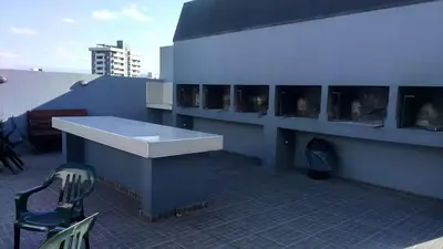 a building with a counter and a chair on a roof at Departamento centrico carlos paz in Villa Carlos Paz
