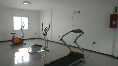 a gym with two exercise bikes in a room at Departamento centrico carlos paz in Villa Carlos Paz