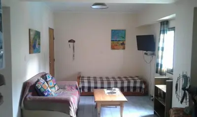 a living room with a couch and a table at Departamento Centro Villa Carlos Paz in Villa Carlos Paz