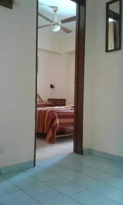 a view of a bedroom with a bed through a doorway at Departamento Centro Villa Carlos Paz in Villa Carlos Paz
