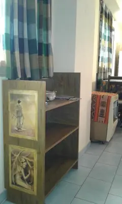 a wooden shelf with paintings on it in a room at Departamento Centro Villa Carlos Paz in Villa Carlos Paz