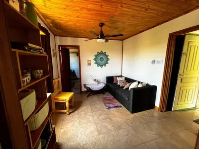 a living room with a black couch and a ceiling at el PARAISO in Villa Anizacate