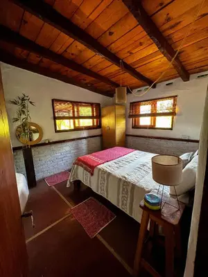 a bedroom with a bed in a room with wooden ceilings at el PARAISO in Villa Anizacate