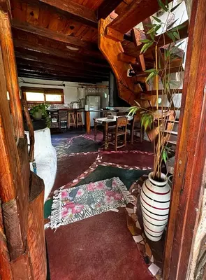 a living room with a vase with a plant in it at el PARAISO in Villa Anizacate