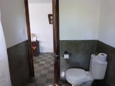 a bathroom with a white toilet in a room at La Quebradita in San Javier