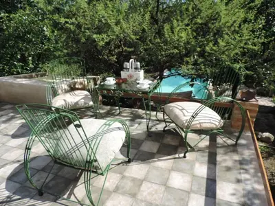 a patio with three chairs and a table and a pool at La Quebradita in San Javier