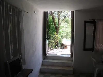 a window in a house with stairs leading to a yard at La Quebradita in San Javier