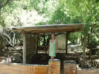 a woman standing in front of a wooden structure at La Quebradita in San Javier