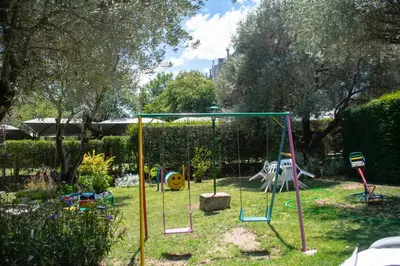a playground with a swing set in a yard at Cabañas Monteolivos in Merlo