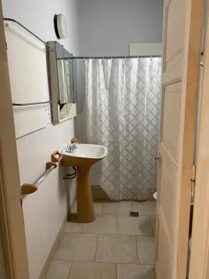 a small bathroom with a sink and a shower at Departamento Hospital Privado Quality maternidad Con cochera in Cordoba