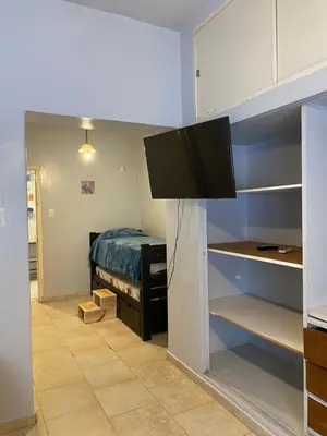 a bedroom with a bed and a tv in a room at Departamento Hospital Privado Quality maternidad Con cochera in Cordoba