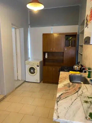 a kitchen with a sink and a washing machine at Departamento Hospital Privado Quality maternidad Con cochera in Cordoba