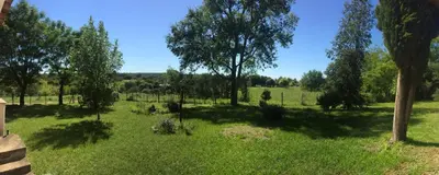 a field of grass with trees in the background at Casa en Villa Amancay in Amboy
