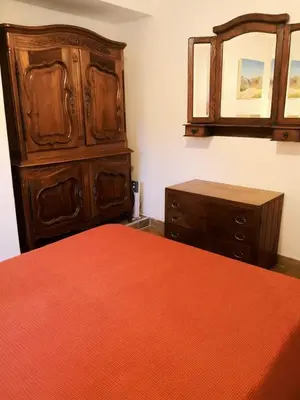 a bedroom with a bed and a dresser and a mirror at Casa en Villa Amancay in Amboy