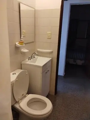 a bathroom with a toilet and a sink at Buenas Vibras in Villa Carlos Paz